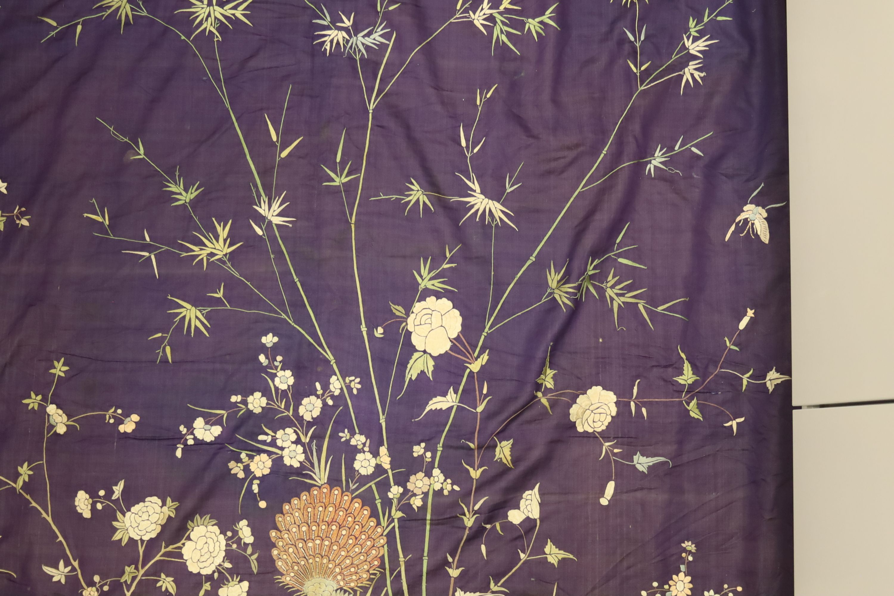 An early 20th century Chinese purple silk embroidered throw edged with trimming, 130 x 134cm